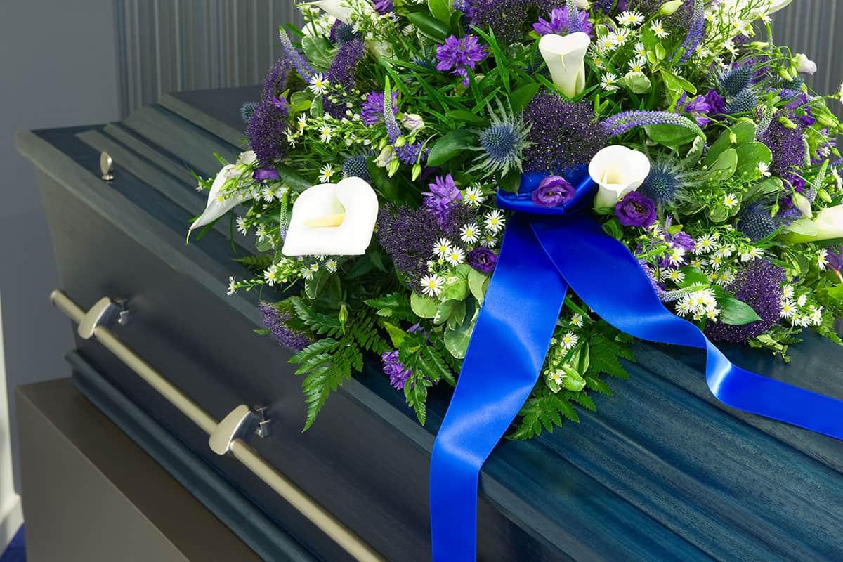 Flowers laying atop a casket.